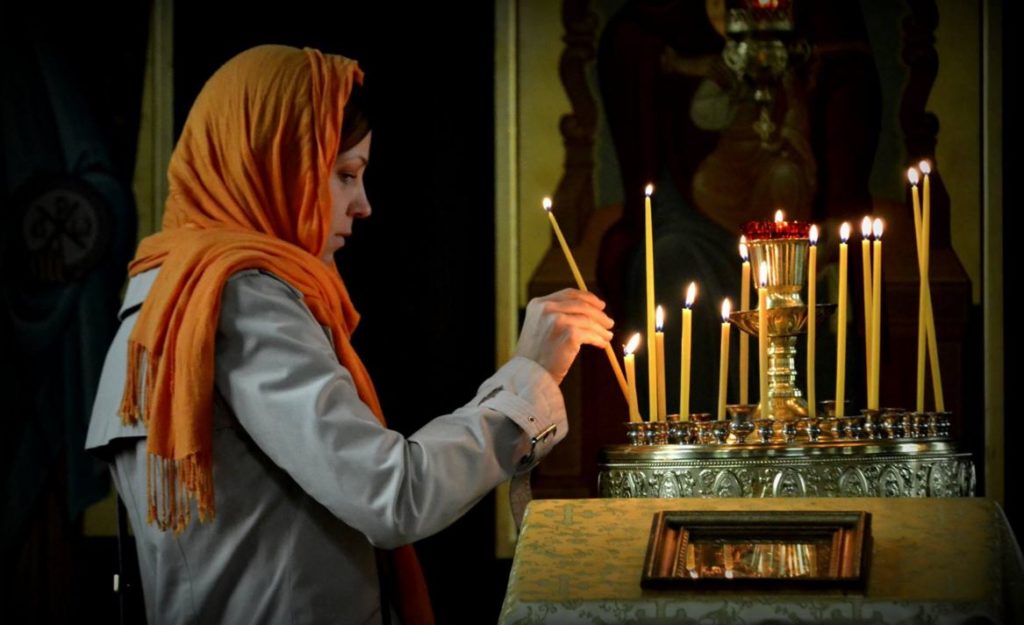 woman prayer candles